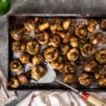 Baked champignons. Mushrooms in sauce. Hot appetizer. Fried vege