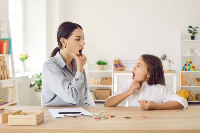Happy,Child,And,Young,Female,Speech,Therapist,Or,Mother,Doing